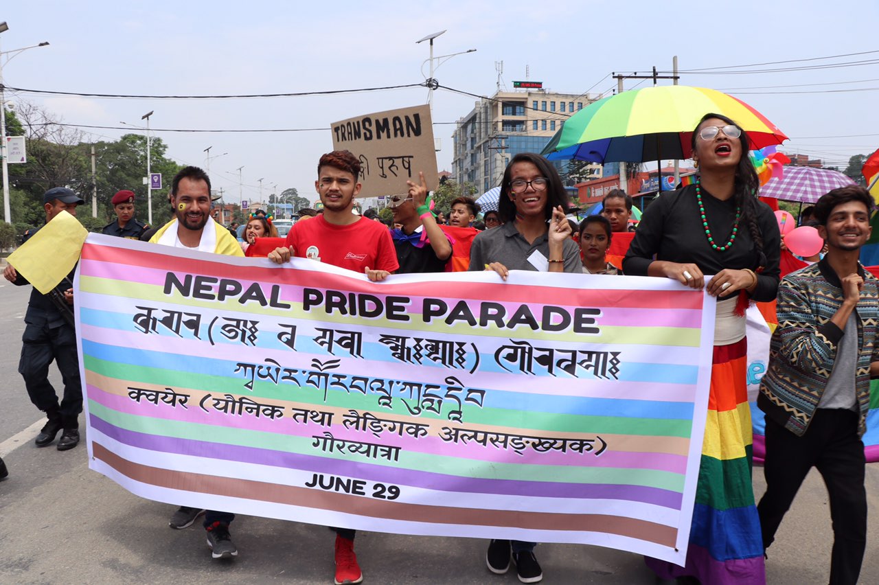 In the image appears a group of people holding banners for Nepal Pride Parade 2019.