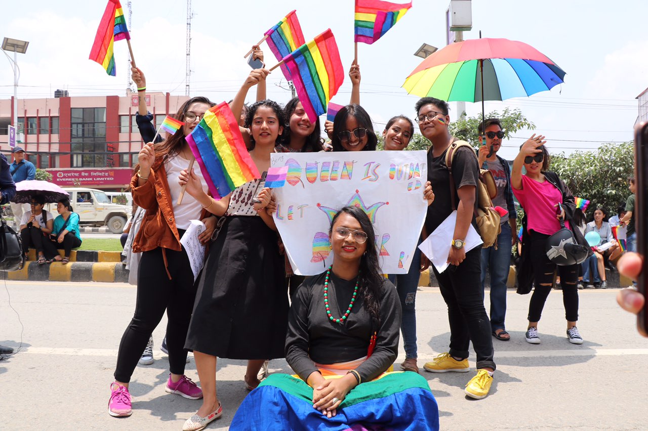 In the image appears a group of people holding flags on Nepal Pride Parade 2019.